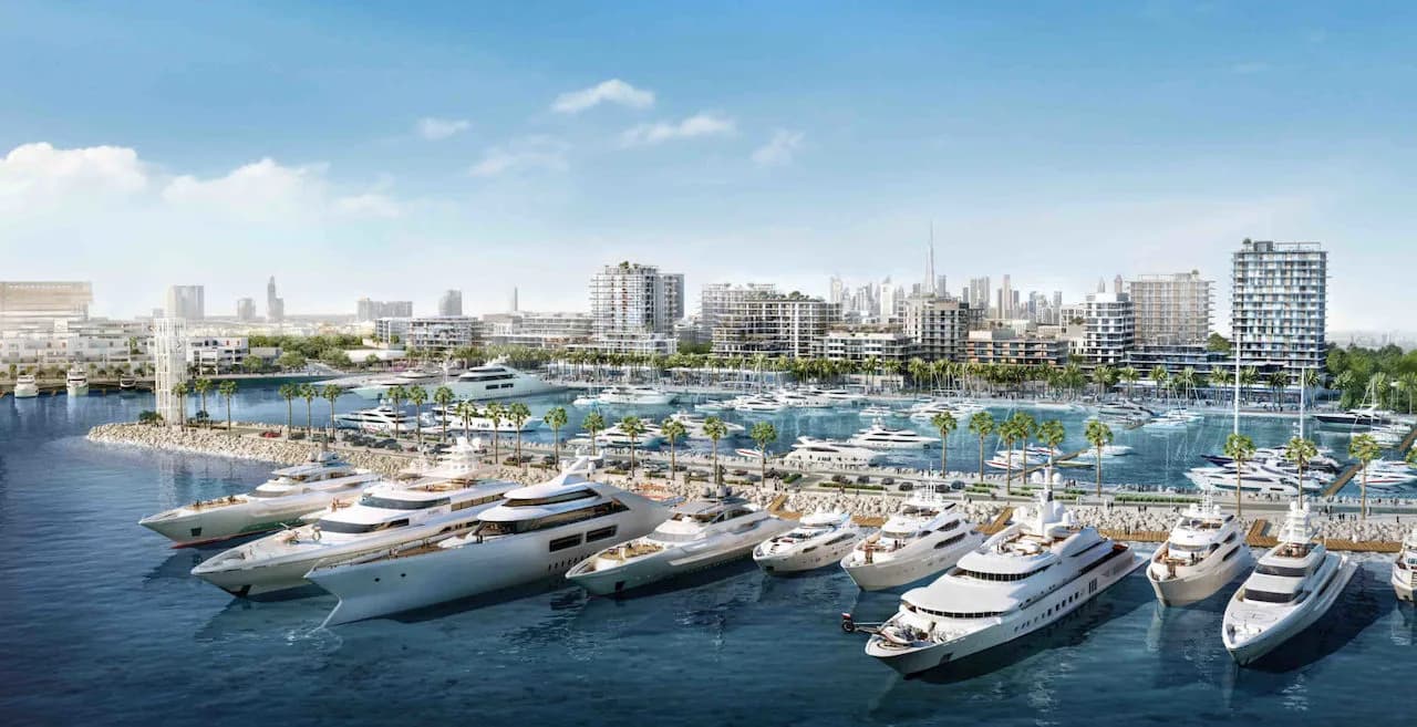 Superyachts berthed at the Rashid Yachts & Marina promenade with Emaar waterfront residences and the Dubai skyline behind